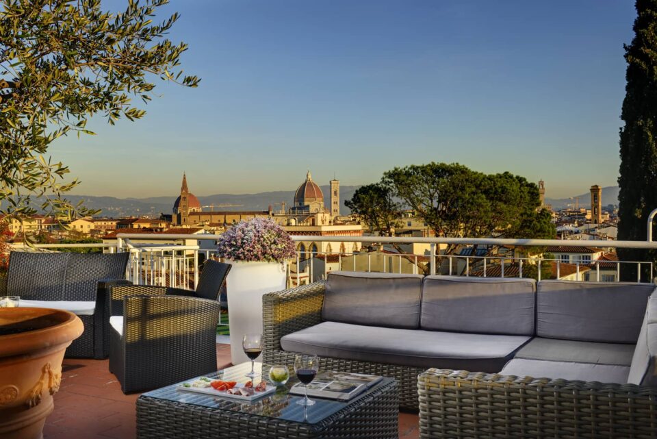 Terrazza Rossini rooftop bar in Florence, Italy. Terrace patio with tables overlooking Florence historic Center