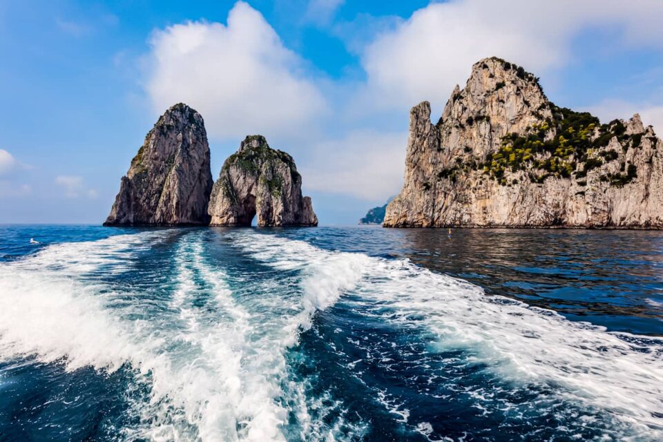 The Faraglioni in Capri Island seen from the boat, a must-visit on your Amalfi Coast Itinerary